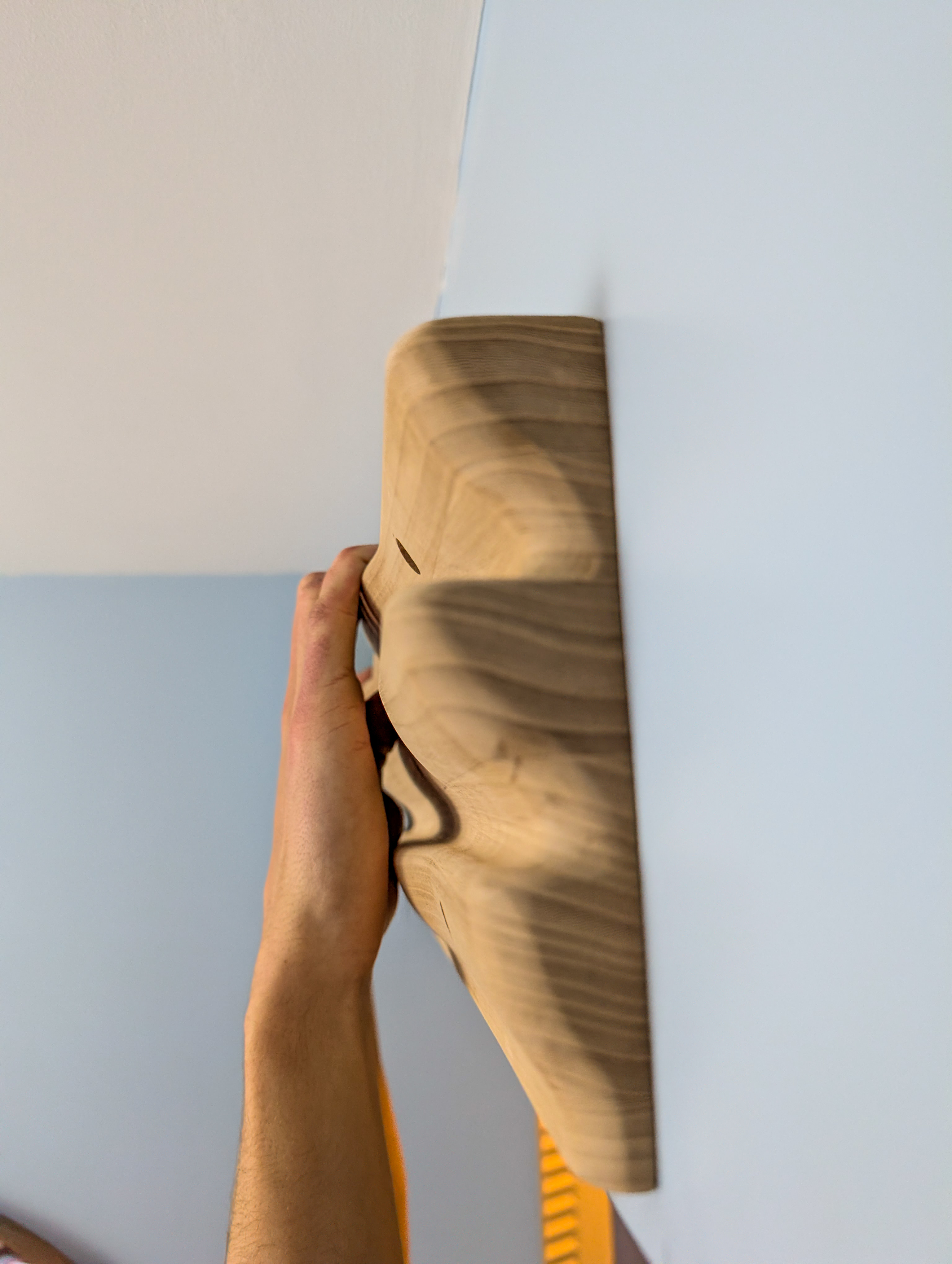 The Cascade Hangboard mounted on a wall — in use